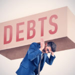 A man holding a Debts sign